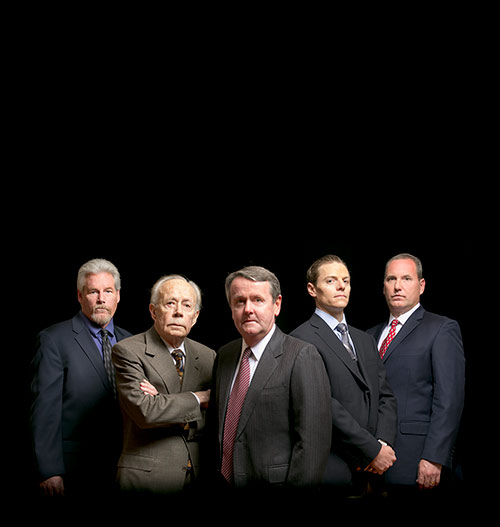 Photo of the firm's attorneys on black backdrop